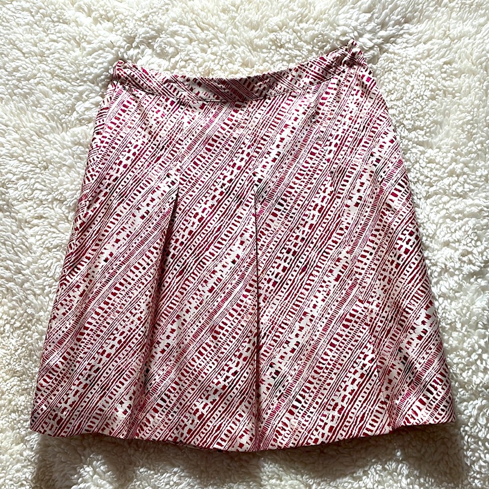 Pretty red pleated skirt. 100% silk with side zipper.